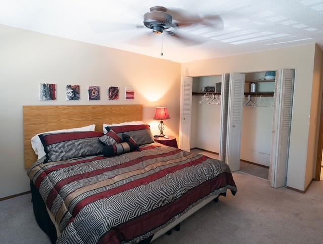 2720 Dale St N Unit C206, Roseville, MN 55113 - bedroom featuring multiple closets, carpet, and ceiling fan