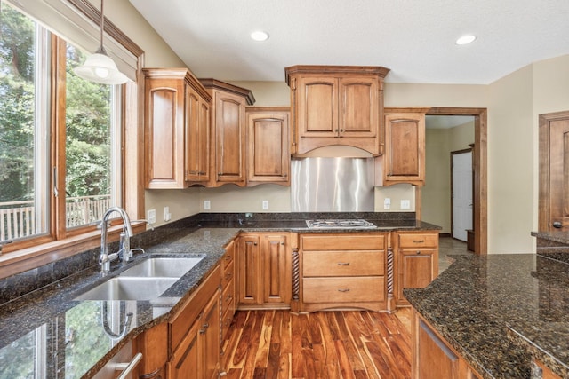 18658 Ponderosa Ct, Eden Prairie, MN 55347 - kitchen with dark wood finished floors, stainless steel gas cooktop, pendant lighting, recessed lighting, and dark stone countertops