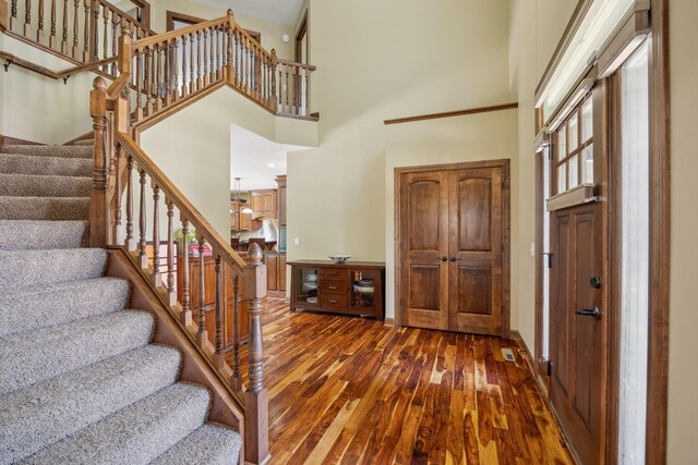 18658 Ponderosa Ct, Eden Prairie, MN 55347 - foyer featuring a towering ceiling, dark wood-type flooring, stairway, and plenty of natural light