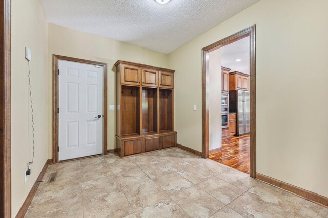 18658 Ponderosa Ct, Eden Prairie, MN 55347 - mudroom with baseboards and a textured ceiling