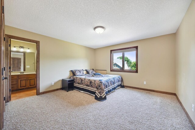18658 Ponderosa Ct, Eden Prairie, MN 55347 - bedroom with light carpet, a textured ceiling, and ensuite bath