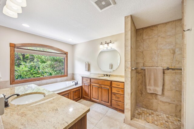 18658 Ponderosa Ct, Eden Prairie, MN 55347 - bathroom featuring two vanities, a bath, tiled shower, recessed lighting, and tile patterned flooring