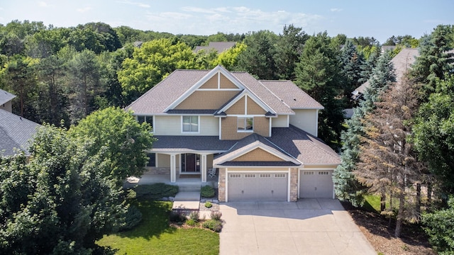 18658 Ponderosa Ct, Eden Prairie, MN 55347 - craftsman inspired home featuring driveway, stone siding, a garage, and a porch