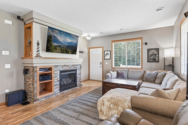 14220 Avalon Path Unit 1102, Rosemount, MN 55068 - living area with a textured ceiling, a fireplace, wood finished floors, and healthy amount of natural light