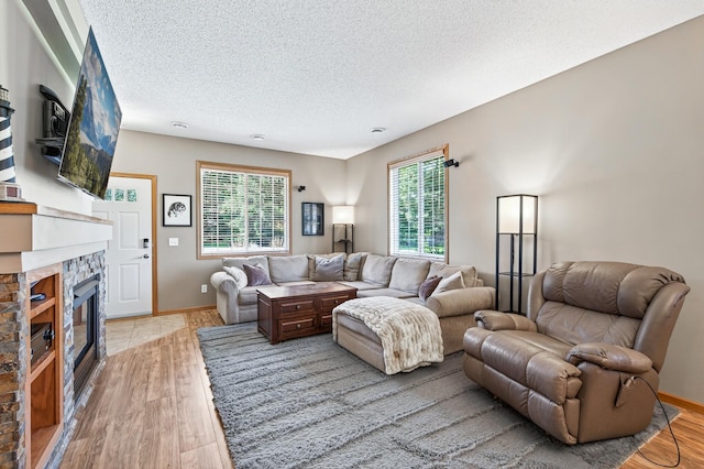 14220 Avalon Path Unit 1102, Rosemount, MN 55068 - living area featuring plenty of natural light, a textured ceiling, light wood finished floors, and a fireplace
