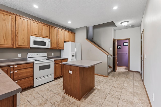 14220 Avalon Path Unit 1102, Rosemount, MN 55068 - kitchen with white appliances, a kitchen island, a textured ceiling, brown cabinetry, and recessed lighting