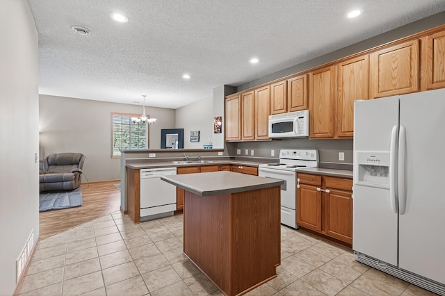 14220 Avalon Path Unit 1102, Rosemount, MN 55068 - kitchen featuring white appliances, a peninsula, a chandelier, recessed lighting, and a textured ceiling
