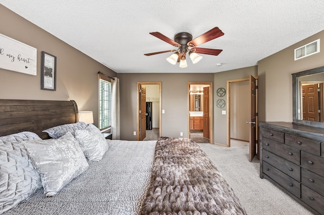 14220 Avalon Path Unit 1102, Rosemount, MN 55068 - bedroom with a spacious closet, light colored carpet, connected bathroom, ceiling fan, and a textured ceiling