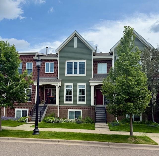 8124 Oakview Ln N Unit 47, Maple Grove, MN 55369 - view of property with brick siding and stairway