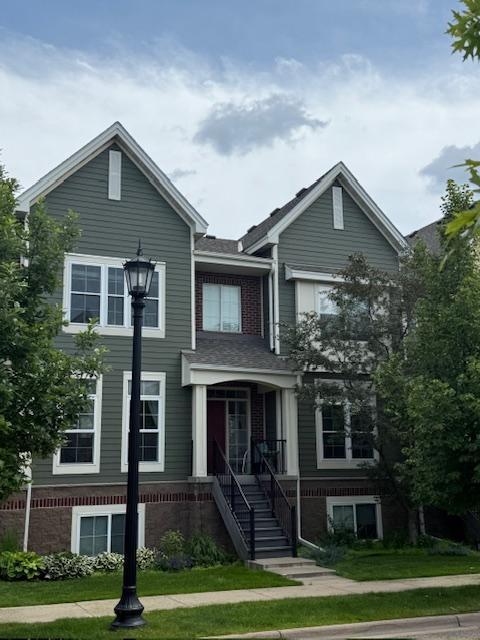 8124 Oakview Ln N Unit 47, Maple Grove, MN 55369 - traditional-style home featuring brick siding and a front lawn