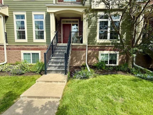8124 Oakview Ln N Unit 47, Maple Grove, MN 55369 - doorway to property featuring a yard and brick siding