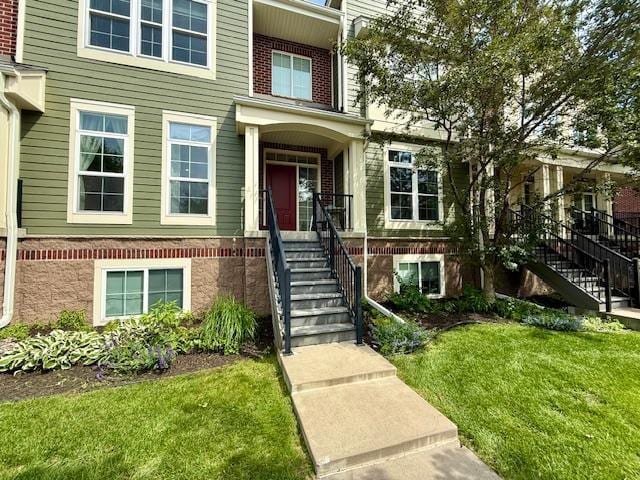 8124 Oakview Ln N Unit 47, Maple Grove, MN 55369 - doorway to property featuring a yard and brick siding