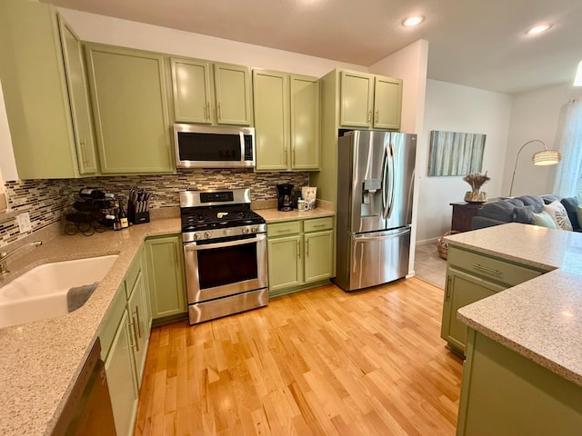 8124 Oakview Ln N Unit 47, Maple Grove, MN 55369 - kitchen featuring green cabinetry, stainless steel appliances, decorative backsplash, light wood-style floors, and recessed lighting