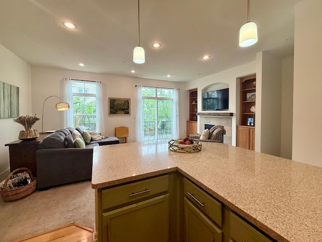 8124 Oakview Ln N Unit 47, Maple Grove, MN 55369 - kitchen with open floor plan, a tiled fireplace, hanging light fixtures, recessed lighting, and light stone countertops