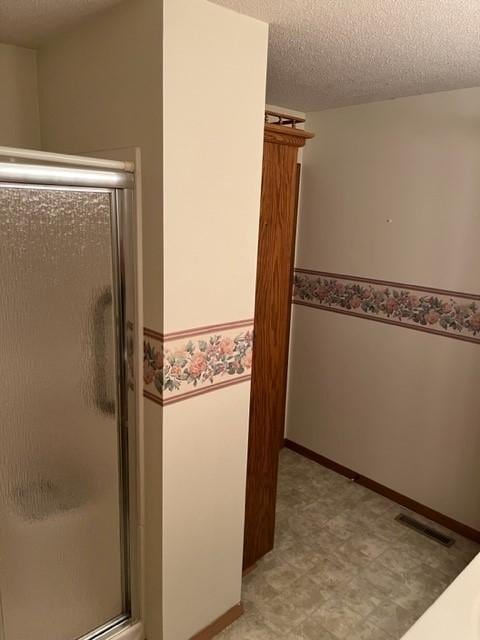 324 7th St, Windom, MN 56101 - bathroom with a stall shower, tile patterned floors, and a textured ceiling
