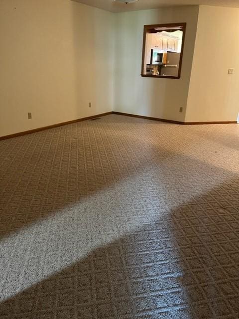 324 7th St, Windom, MN 56101 - carpeted empty room with baseboards