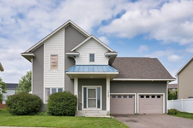 12344 67th St NE, Otsego, MN 55330 - view of front of property with asphalt driveway, a standing seam roof, a garage, and a metal roof