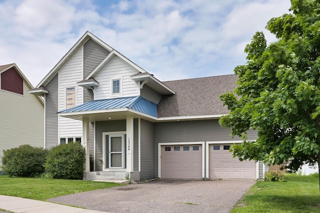 12344 67th St NE, Otsego, MN 55330 - view of front of house featuring a standing seam roof, a garage, driveway, a metal roof, and a front lawn