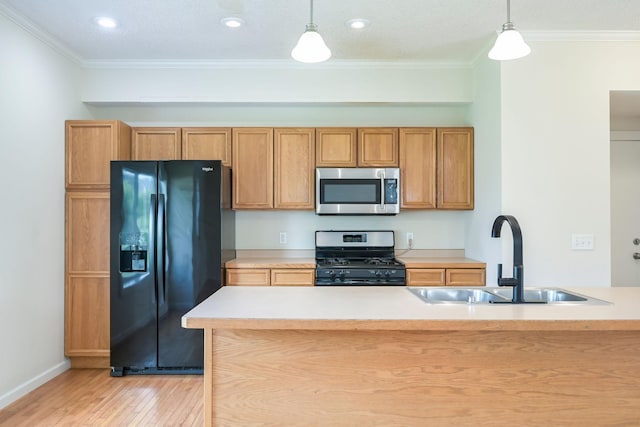 12344 67th St NE, Otsego, MN 55330 - kitchen with stainless steel microwave, gas stove, black fridge, light wood-style floors, and pendant lighting