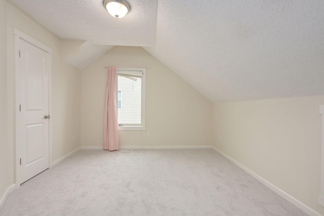 12344 67th St NE, Otsego, MN 55330 - bonus room with a textured ceiling, light carpet, and vaulted ceiling