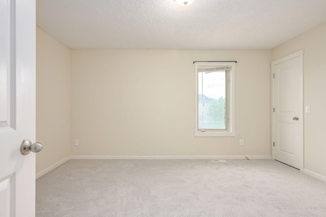 12344 67th St NE, Otsego, MN 55330 - empty room featuring light carpet and a textured ceiling