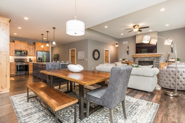 29680 Hidden Forest Blvd, Chisago City, MN 55013 - dining space featuring ceiling fan, recessed lighting, dark wood finished floors, and a stone fireplace