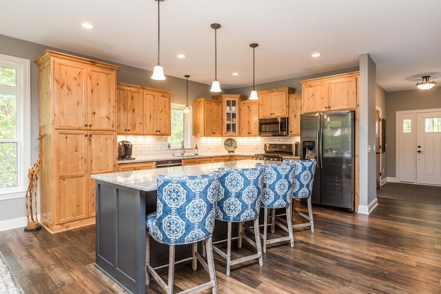 29680 Hidden Forest Blvd, Chisago City, MN 55013 - kitchen featuring stainless steel appliances, light brown cabinets, healthy amount of natural light, tasteful backsplash, and recessed lighting