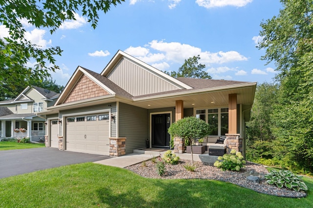 29680 Hidden Forest Blvd, Chisago City, MN 55013 - craftsman inspired home featuring an attached garage, stone siding, a front yard, and board and batten siding