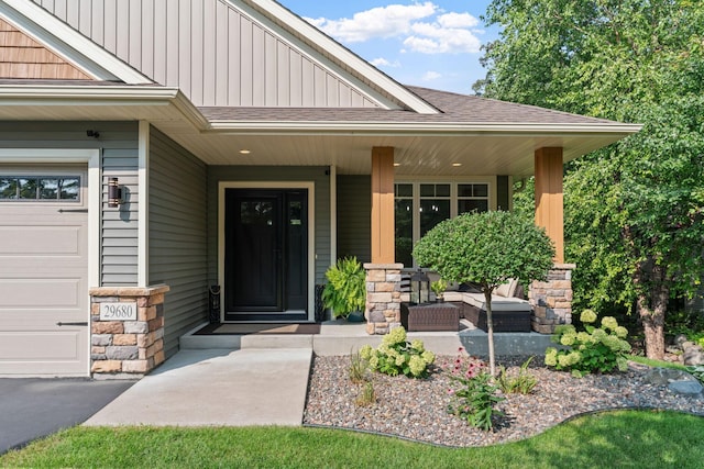 29680 Hidden Forest Blvd, Chisago City, MN 55013 - entrance to property featuring covered porch, board and batten siding, stone siding, and a shingled roof