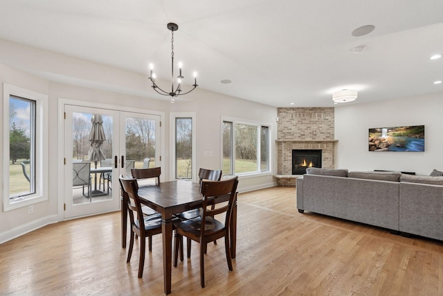 4584 162nd Ln NW, Andover, MN 55304 - dining area featuring a chandelier, light wood-style floors, a brick fireplace, and recessed lighting