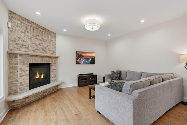 4584 162nd Ln NW, Andover, MN 55304 - living area featuring a brick fireplace, light wood-type flooring, and recessed lighting