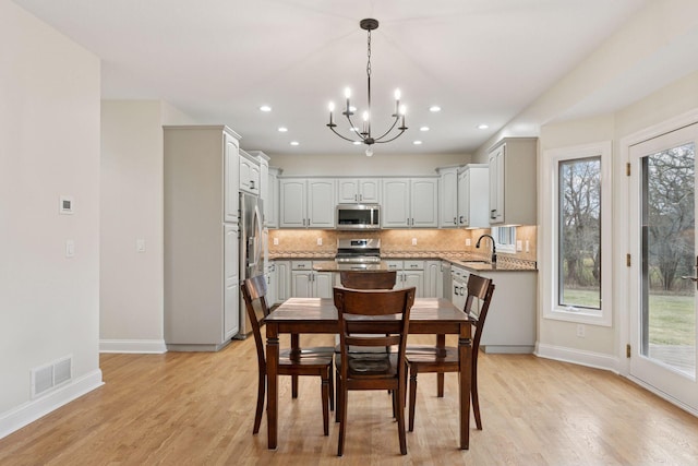 4584 162nd Ln NW, Andover, MN 55304 - dining area with a chandelier, light wood finished floors, and recessed lighting