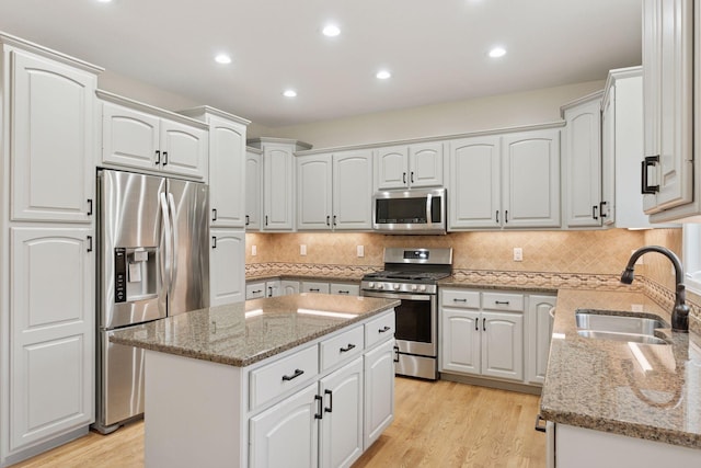 4584 162nd Ln NW, Andover, MN 55304 - kitchen with stainless steel appliances, light stone countertops, white cabinetry, and recessed lighting