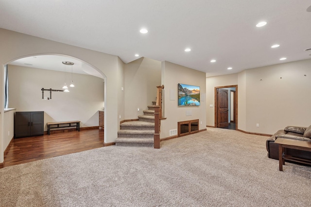 4584 162nd Ln NW, Andover, MN 55304 - living area with carpet flooring, arched walkways, recessed lighting, and stairway