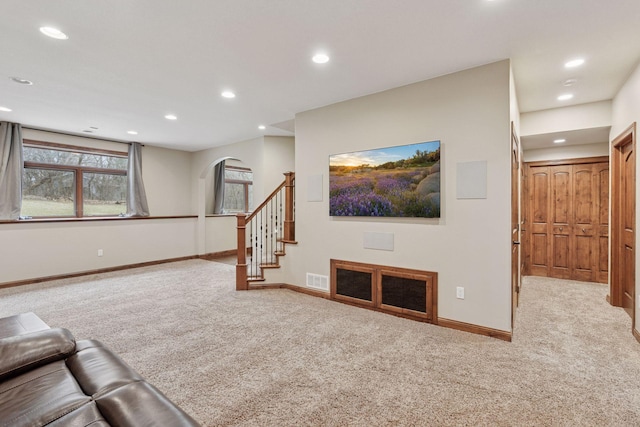 4584 162nd Ln NW, Andover, MN 55304 - unfurnished living room featuring carpet, recessed lighting, arched walkways, and stairs