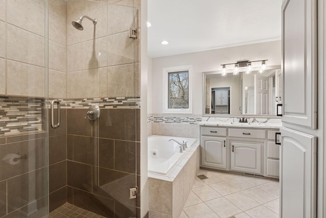 4584 162nd Ln NW, Andover, MN 55304 - bathroom with vanity, a whirlpool tub, a stall shower, tile patterned flooring, and recessed lighting