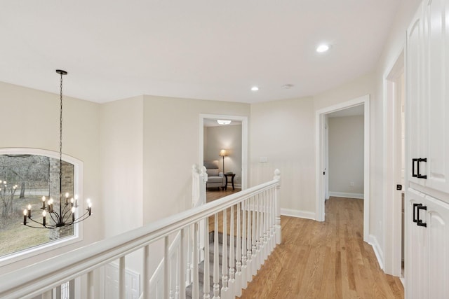 4584 162nd Ln NW, Andover, MN 55304 - hallway featuring a chandelier, light wood-type flooring, recessed lighting, and an upstairs landing