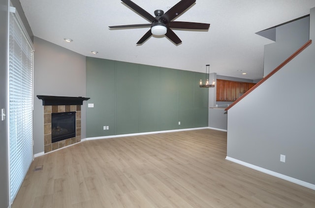 8397 Norwood Ln N, Maple Grove, MN 55311 - unfurnished living room with ceiling fan, light wood-style flooring, a fireplace, a chandelier, and recessed lighting