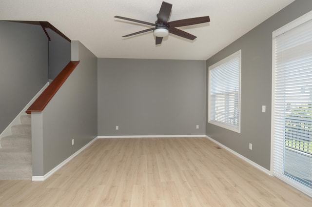 8397 Norwood Ln N, Maple Grove, MN 55311 - unfurnished room featuring ceiling fan, light wood-type flooring, and stairway