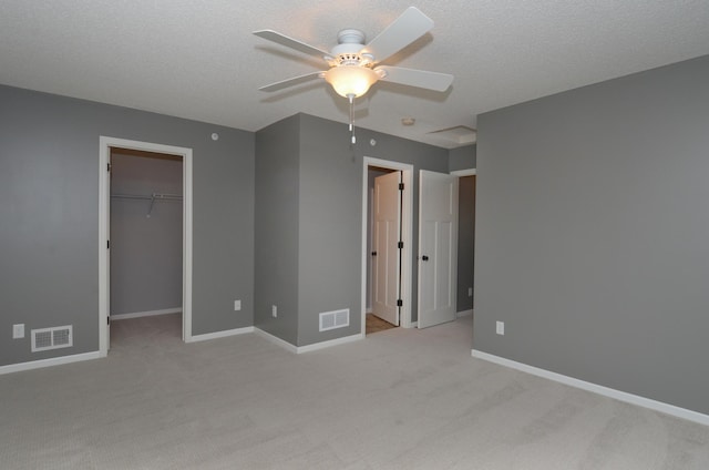 8397 Norwood Ln N, Maple Grove, MN 55311 - unfurnished bedroom with light carpet, a walk in closet, a closet, and ceiling fan