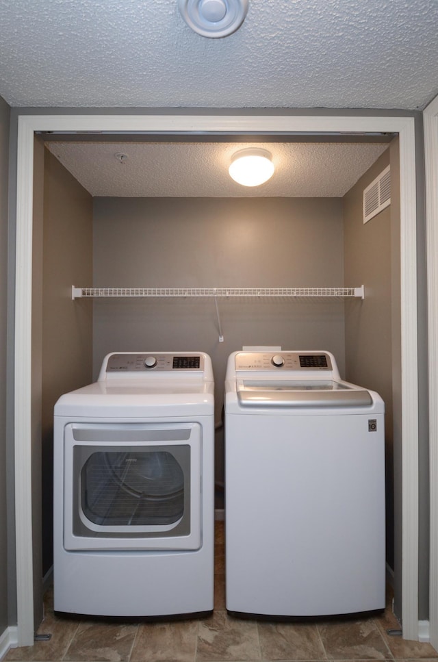 8397 Norwood Ln N, Maple Grove, MN 55311 - washroom featuring washing machine and clothes dryer and a textured ceiling