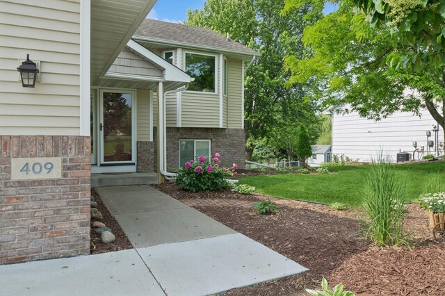 409 Birch Ave NW, Saint Michael, MN 55376 - entrance to property featuring a lawn and roof with shingles