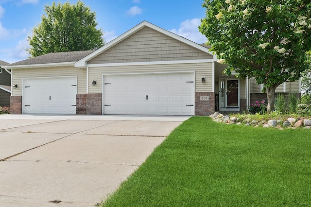 409 Birch Ave NW, Saint Michael, MN 55376 - view of front of home with brick siding, an attached garage, concrete driveway, and a front lawn