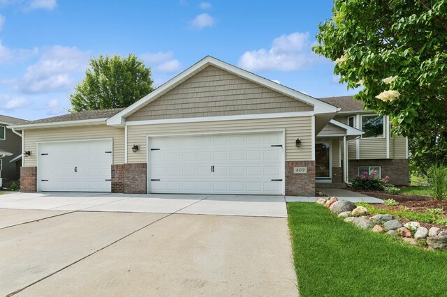 409 Birch Ave NW, Saint Michael, MN 55376 - view of front facade featuring brick siding, concrete driveway, and an attached garage