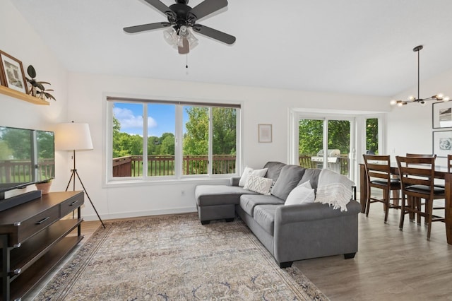 409 Birch Ave NW, Saint Michael, MN 55376 - living area featuring vaulted ceiling, a chandelier, plenty of natural light, wood finished floors, and ceiling fan