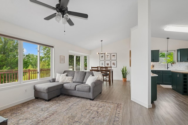 409 Birch Ave NW, Saint Michael, MN 55376 - living area with vaulted ceiling, wood finished floors, a ceiling fan, and a chandelier