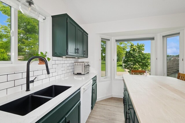 409 Birch Ave NW, Saint Michael, MN 55376 - kitchen with green cabinetry, white dishwasher, decorative backsplash, light wood-type flooring, and light stone counters