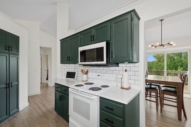 409 Birch Ave NW, Saint Michael, MN 55376 - kitchen with white appliances, green cabinets, light countertops, decorative backsplash, and a chandelier