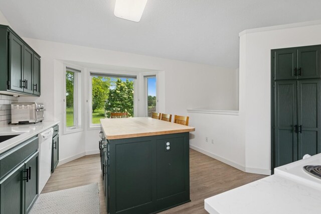409 Birch Ave NW, Saint Michael, MN 55376 - kitchen with green cabinetry, dishwasher, light wood finished floors, and butcher block counters