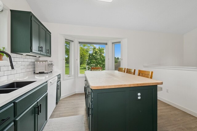 409 Birch Ave NW, Saint Michael, MN 55376 - kitchen with green cabinets, a kitchen island, light wood-style floors, and tasteful backsplash